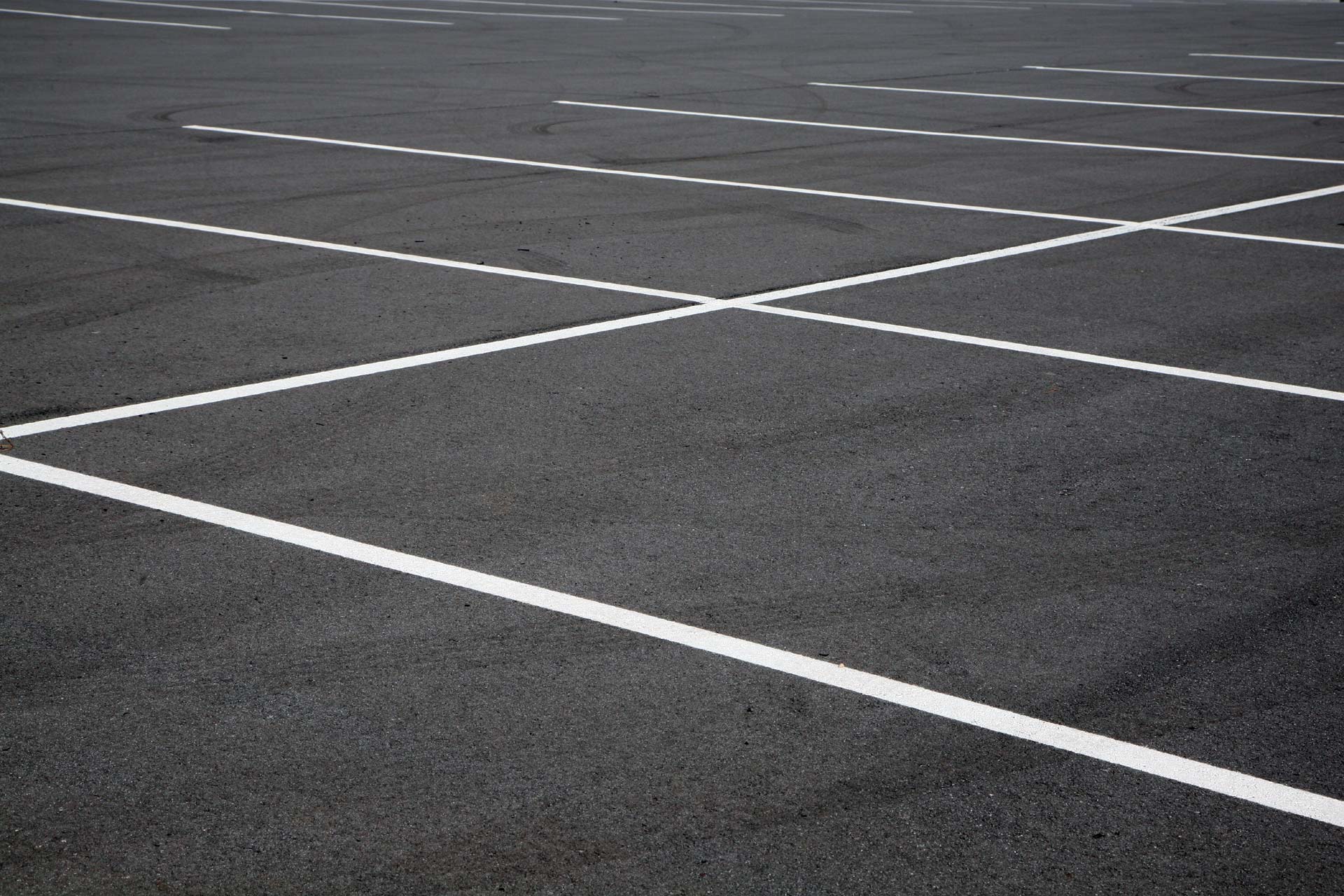 Freshly laid asphalt carpark with painted lines
